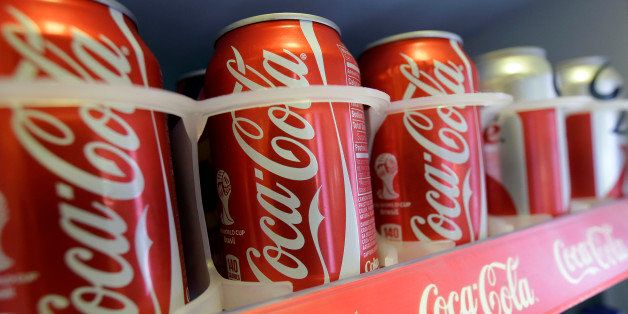In this June 30, 2014 photo cans of Coca-Cola soda pop are shown in the refrigerator inside of Chile Lindo in San Francisco. San Francisco and Berkeley are aiming to become the first U.S. cities to pass per-ounce taxes on sugary drinks. (AP Photo/Jeff Chiu)