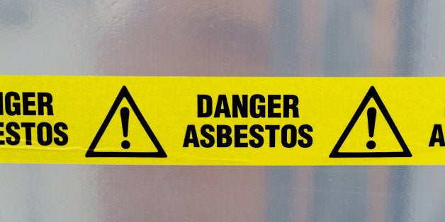 Danger Asbestos yellow warning tape close up