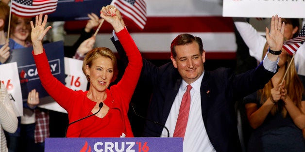 Republican U.S. presidential candidate Ted Cruz raises the arm of his running mate Carly Fiorina at a campaign rally where he