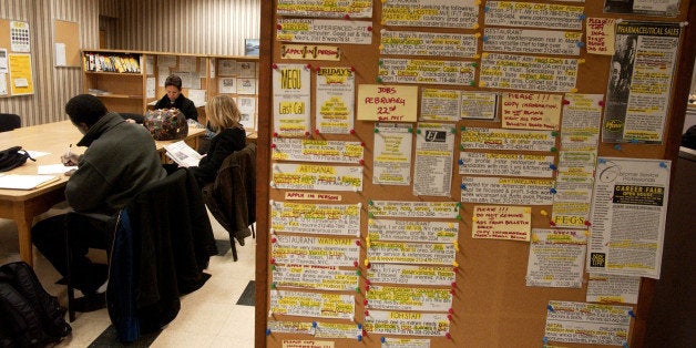 UNITED STATES - FEBRUARY 25: Job postings hang on a wall near a table of job seekers in a New York State Labor Department ca