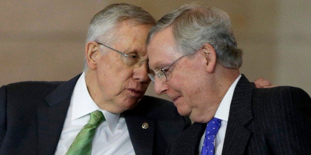 Senate Minority Leader Mitch McConnell (R-KY) (R) and Senate Majority Leader Harry Reid (D-NV) (L) chat during a Congressional Gold Medal ceremony for members of the Civil Air Patrol for their valor and dedication during World War II at the U.S. Capitol in Washington December 10, 2014. REUTERS/Gary Cameron (UNITED STATES - Tags: POLITICS MILITARY CONFLICT TPX IMAGES OF THE DAY)