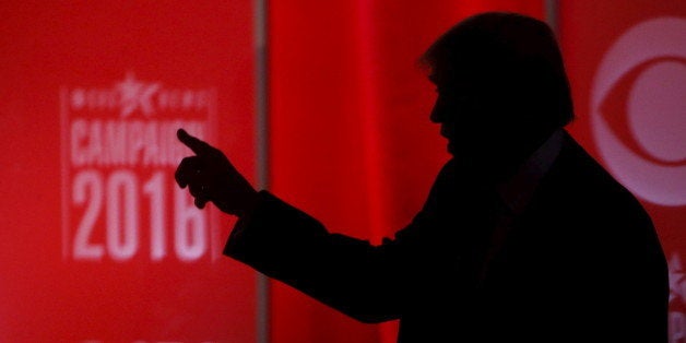 Republican U.S. presidential candidate businessman Donald Trump speaks to someone offstage during a commercial break at the R