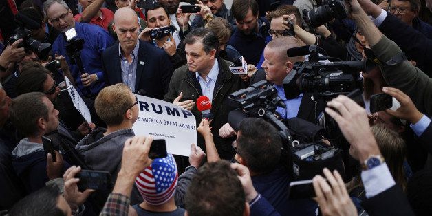 Senator Ted Cruz, a Republican from Texas and 2016 presidential candidate, speaks with supporters of Donald Trump, president and chief executive of Trump Organization Inc. and 2016 Republican presidential candidate, demonstrating outside a campaign event at The Mill restaurant in Marion, Indiana, U.S., on Monday, May 2, 2016. Even as his campaign struggles for survival, Cruz dominated weekend delegate selection contests that he and other Republicans hope could block Donald Trump from winning the party's nomination at their national convention. Photographer: Luke Sharrett/Bloomberg via Getty Images 