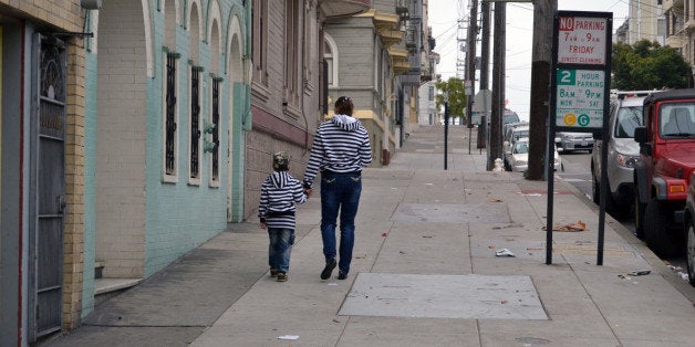 little girl and boy are walking on the street