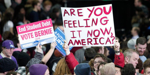 YPSILANTI, MI - FEBRUARY 15: Supporters of U.S. Senator and Democratic Presidential Candidate Bernie Sanders hold signs at Sanders' first campaign rally in Michigan at Eastern Michigan University February 15th, 2016 in Ypsilanti, Michigan. At his 'A Future To Believe In' rally, Sanders spoke on a wide range of issues, including his plans to make public colleges and universities tuition-free. The next voting for the Democratic candidates will be the Democratic caucus in Nevada on February 20th. (Photo by Bill Pugliano/Getty Images)