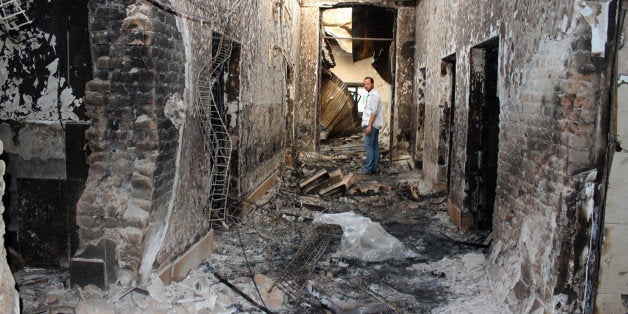 FILE - In this Oct. 16, 2015, file photo, an employee of Doctors Without Borders stands inside the charred remains of their h