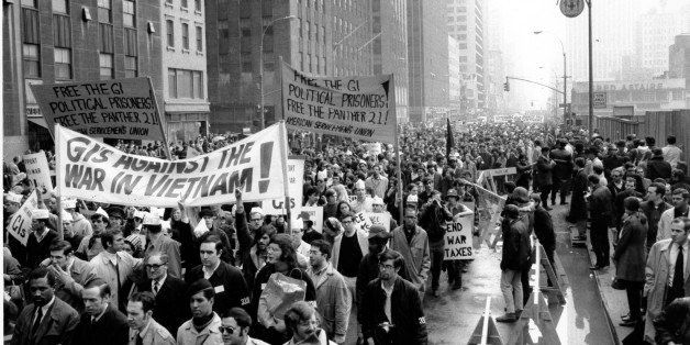 Thousands of anti-Vietnam war protesters march along the Avenue of the America's on 6th Avenue in New York City on April 5, 1969. Many of the protesters wore black arm bands bearing the number "33,000," referring to the American deaths in Vietnam. (AP Photo)
