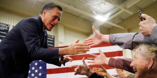 Former Republican presidential candidate Mitt Romney meets with attendees at a Republican presidential candidate, Ohio Gov. John Kasich campaign stop on Monday, March 14, 2016, at Westerville Central High School in Westerville, Ohio. (AP Photo/Matt Rourke)