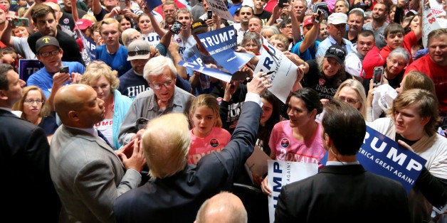 U.S. Republican presidential candidate Donald Trump signs autograph following a campaign rally in Spokane, Washington, U.S.,