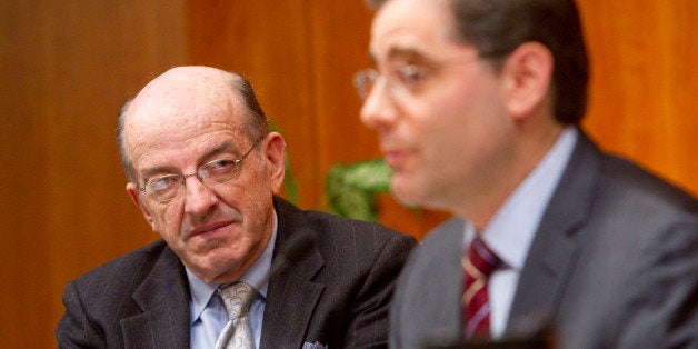 Michael Copps, commissioner of the U.S. Federal Communications Commission, left, listens to Julius Genachowski, chairman of the FCC, during a hearing on net-neutrality rules at the FCC in Washington, D.C., U.S., on Tuesday, Dec. 21, 2010. U.S. regulators banned Internet service providers led by AT&T Inc. and Comcast Corp. from blocking or slowing Web content sent to homes and businesses, while allowing mobile phone companies to put limits on traffic. Photographer: Andrew Harrer/Bloomberg via Getty Images