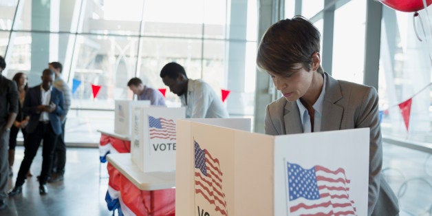 Woman in voting booth at polling place