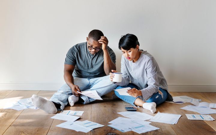 You can buy a house while you're in debt. Whether that's a good idea depends on a few crucial factors.