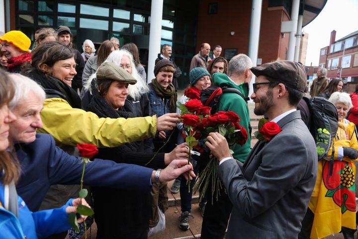 Simon Roscoe Blevins receives red roses from his supporters.