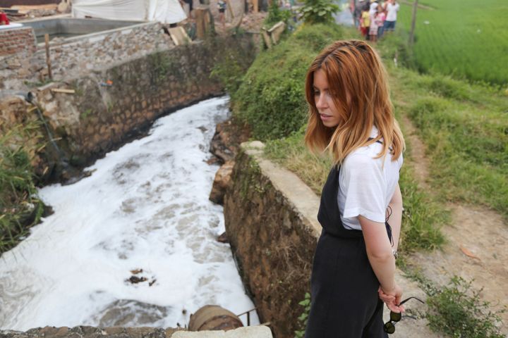 Dooley stands by the polluted Citarum River in Indonesia.