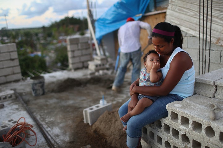 A young woman with her baby aged 9 months after their house in Puerto Rico was destroyed by Hurricane Maria