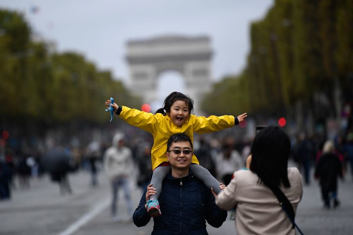 A family poses on the Champs-Elysées on a car-free day in Paris last year.