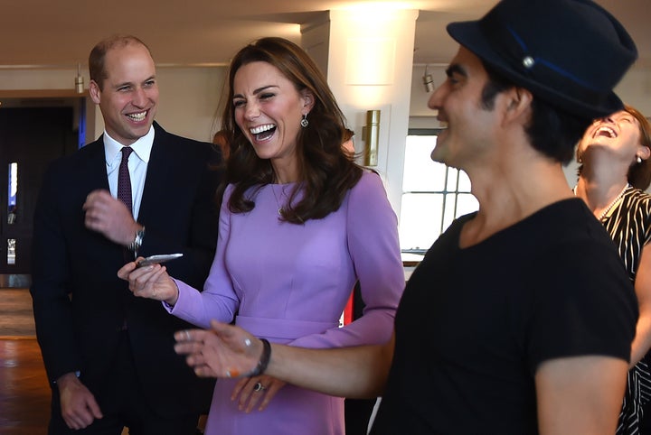 Prince William and Duchess Kate react as they paint with Columbian artist Dairo Vargas on Oct. 9.