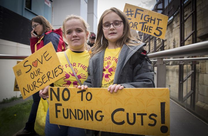 Zoe Ireland and her daughter Alice queue up to enter the Houses of Parliament to protest against the potential closure of five council-run nurseries in Salford could be closed down.