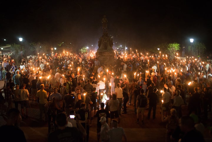 Neo-Nazis and white supremacists encircle counter protestors at the base of a statue of Thomas Jefferson after marching throu