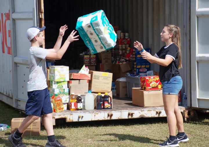 Volunteers help sort incoming donations for families affected by Hurricane Florence in Hampstead.