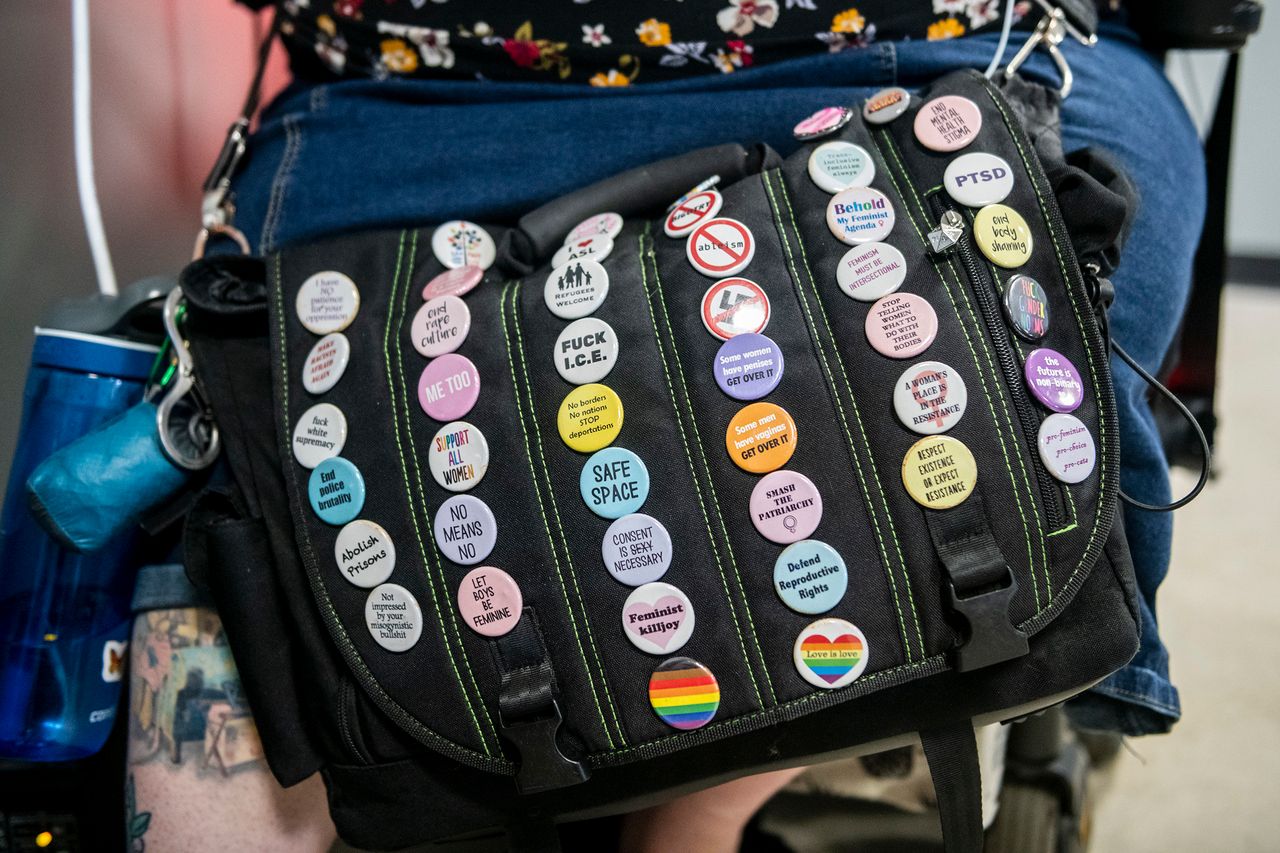 Various buttons from different social causes adorn Grishman's bag.