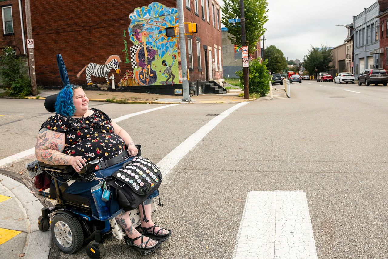 To cross streets, Grishman has to use crosswalks where there is an incline for her wheelchair.