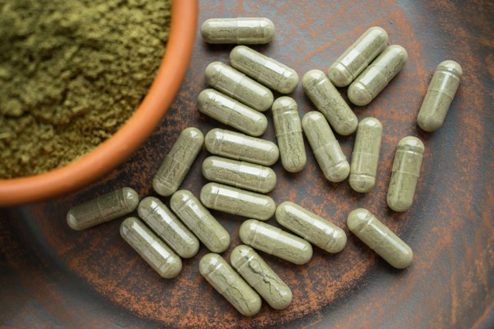 Kratom powder and capsules are seen on a table. Ohio is seeking to ban the popular herbal supplement based on a series of disputed claims.