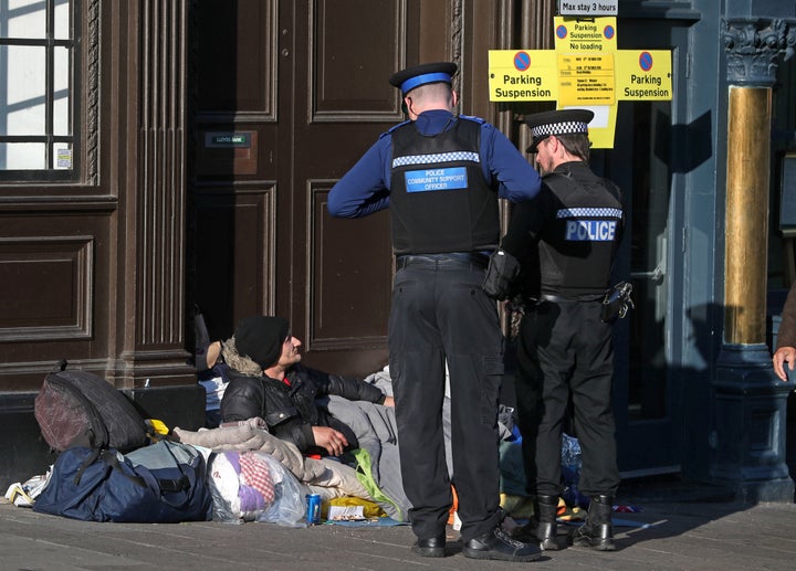 Police officers speaking to a homeless man on Wednesday