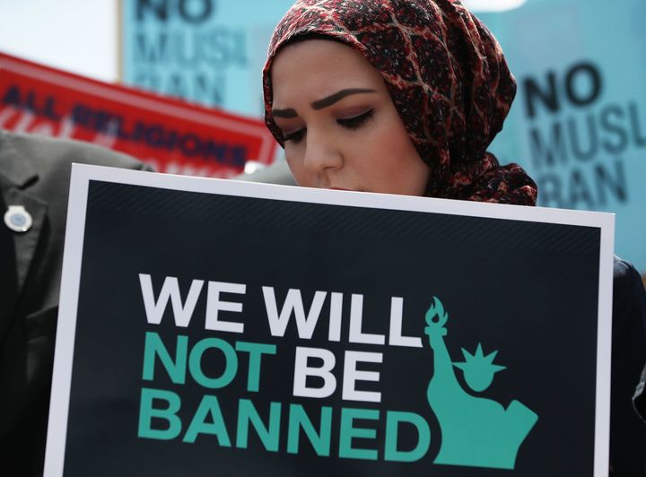 A woman participates in a demonstration against President Donald Trump's travel ban outside the U.S. Supreme Court following a court-issued immigration ruling on June 26, 2018 in Washington, DC.