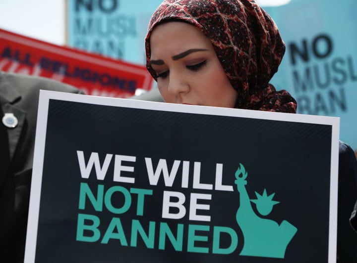 A woman participates in a demonstration against President Donald Trump's travel ban outside the U.S. Supreme Court following a court-issued immigration ruling on June 26, 2018 in Washington, DC.