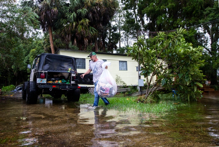 Mitchell Pope tries to salvage what he can from his mobile home on Oct. 10 in St. Marks.