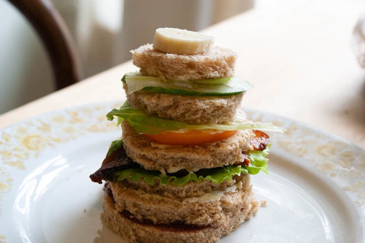 Russian Club Sandwich as described in a recipe in Bee Wilson’s <i>Sandwiches: A Global History</i>. Club sandwiches are classically attributed to Americans but this Russian club features rounds of bread in descending height with jam, cream cheese and butter, in addition to classic club ingredients like bacon, lettuce and tomato.
