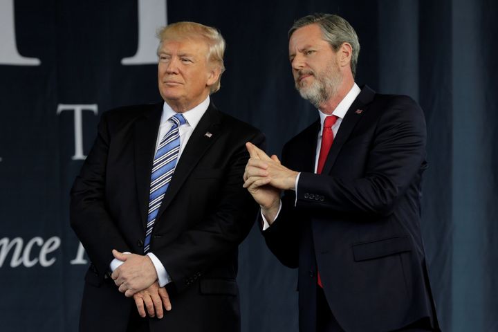 President Donald Trump stands with Liberty University's President Jerry Falwell Jr. after delivering a commencement speech there on May 13, 2017.
