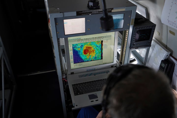 Flight director and NOAA meteorologist Richard Henning looks at a satellite view of Hurricane Michael from his workstation aboard NOAA's Gulfstream IV jet, a high-flying platform used for hurricane forecasting and research, on Oct. 10.