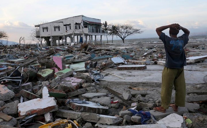 A man surveys the damage after the earthquake and tsunami.