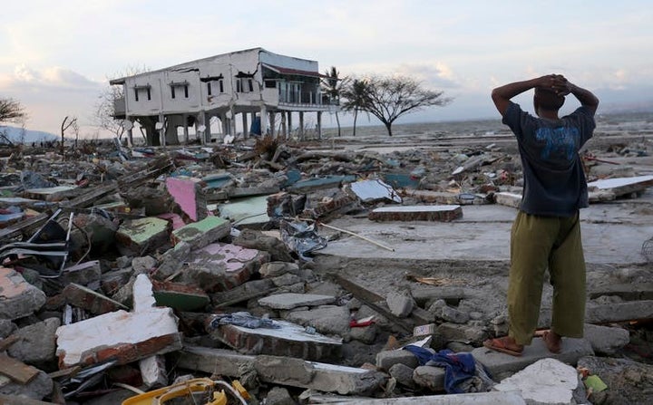 A man surveys the damage after the earthquake and tsunami. 