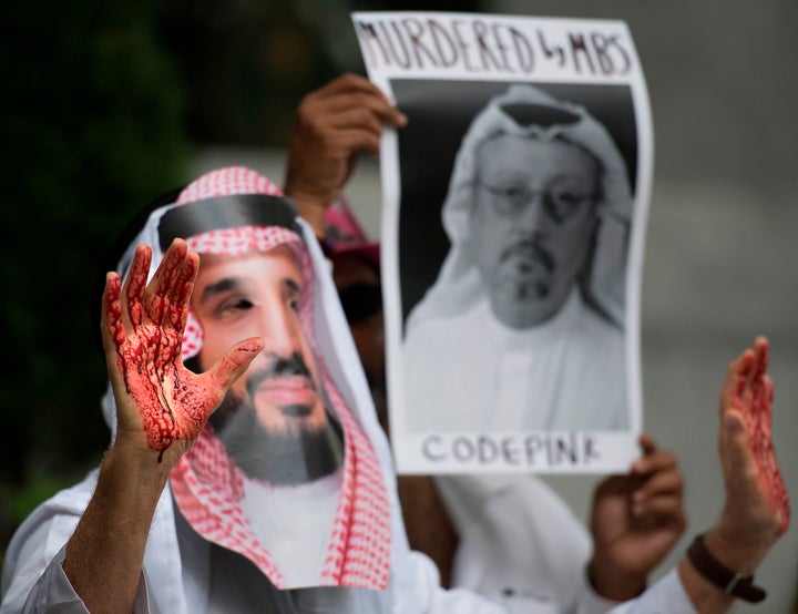 A demonstrator dressed as Saudi Crown Prince Mohammed bin Salman with blood on his hands protests outside the Saudi Embassy i