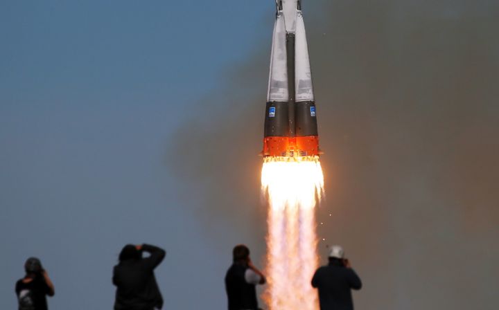 A Soyuz-FG rocket booster blasts off from the Baikonur Cosmodrome carrying the Soyuz MS-10 spacecraft with Roscosmos cosmonaut Alexei Ovchinin and NASA astronaut Nick Hague.