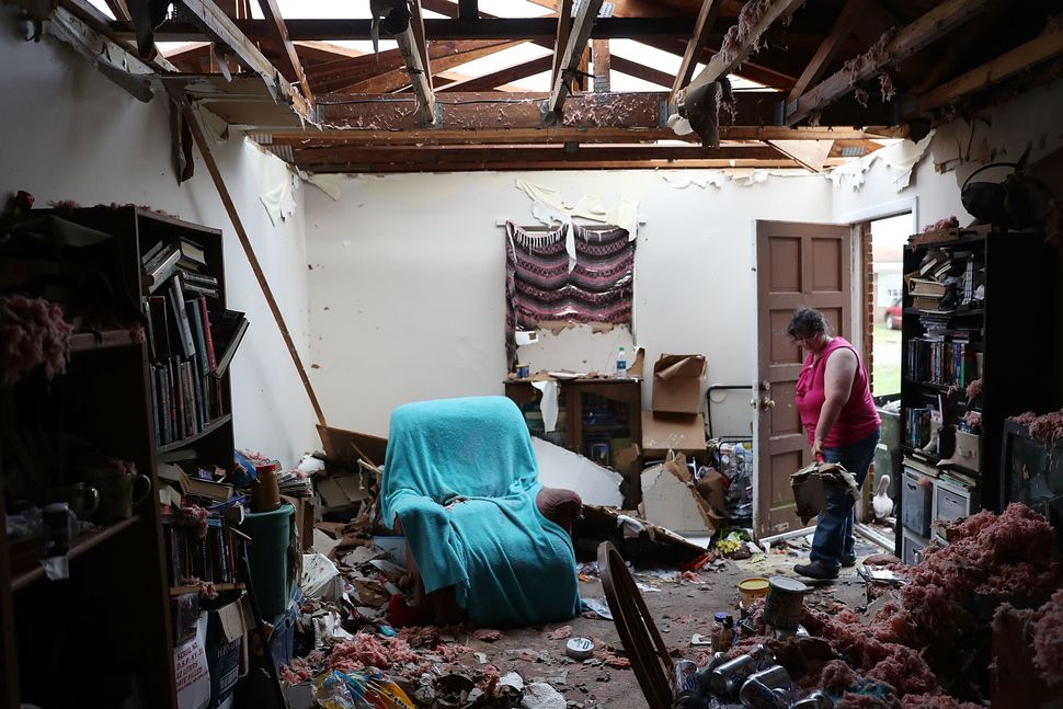 Amanda Logsdon begins the process of trying to clean up her home in Panama City after the roof was blown off.
