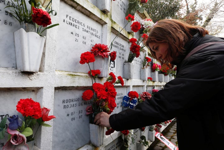 A woman lays flowers at a memorial to victims of Augusto Pinochet's brutal dictatorship in 2017.