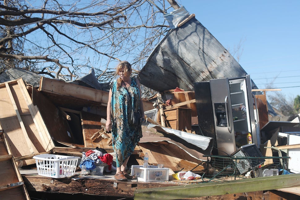 Kathy Coy stands among what is left of her home in Panama City after Hurricane Michael destroyed it. She said she was in the