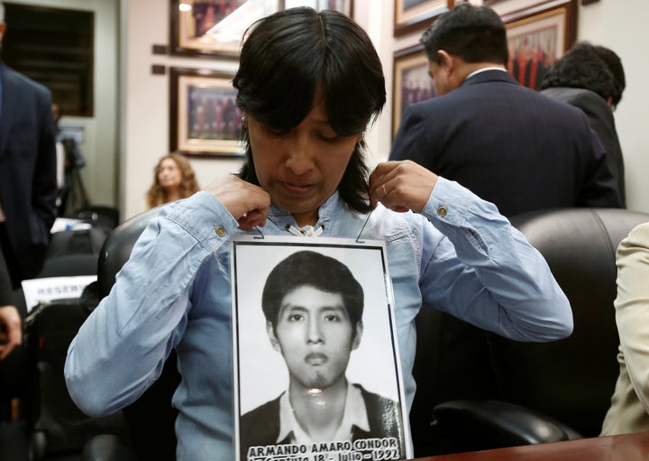 A Peruvian woman with a picture of her brother, a victim of repression during the rule of Alberto Fujimori, before a hearing convened by judges of the Inter-American Court of Human Rights in 2018.