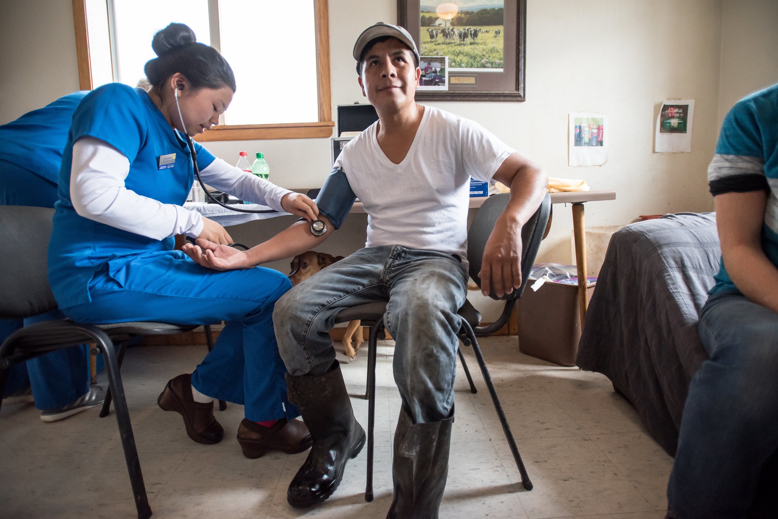 Tecpile gets his blood pressure checked during a health screening with Amaris Vesely, a nursing student from the University o