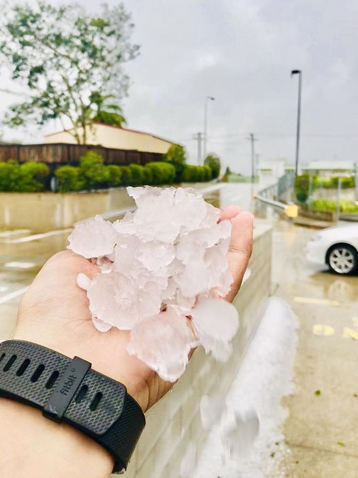A person holds hailstones during a storm in Gympie, Queensland, on Thursday 