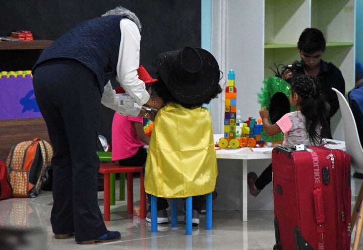 Three migrant minors who had been separated from their family on the U.S. border play in a welcome room upon arrival at La Aurora airport in Guatemala City on Aug. 7.