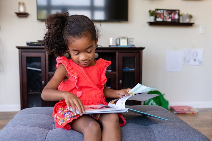 Victoria Daniel looks through a book about her mother, who passed away hours after giving birth to her.