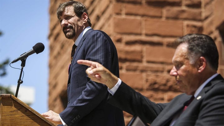 Henry Nicholas speaks, as Orange County District Attorney Tony Rackauckas gestures next to him during a 2013 victims’ rights