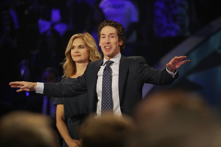 Joel Osteen, the pastor of Lakewood Church, stands with his wife, Victoria Osteen, as he conducts a service at his church on Sept. 3, 2017 in Houston, Texas.