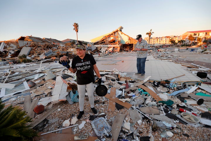 Lavonia Fortner helps her father-in-law, John E. Fortner, search for memorabilia his wife collected, in the aftermath of Hurricane Michael in Mexico Beach, Fla., Saturday, Oct. 13, 2018. His wife died in 2010 but his home was destroyed by the storm. 