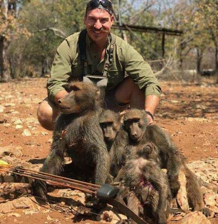 Idaho Fish and Game Commissioner Blake Fischer poses with "a whole family of baboons" that he said he killed in Africa.